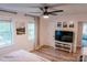 Bedroom with a ceiling fan, hardwood floors, two windows, and a TV on a console at 1699 Riverdale Dr, Rock Hill, SC 29732