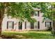 Charming two-story home featuring a well-manicured lawn and black shutters and front door at 1699 Riverdale Dr, Rock Hill, SC 29732