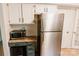 Practical kitchen area with a stainless steel refrigerator, microwave, and compact workstation at 1699 Riverdale Dr, Rock Hill, SC 29732