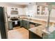 Well-lit kitchen with granite countertops, stainless steel appliances, and updated cabinets at 1699 Riverdale Dr, Rock Hill, SC 29732