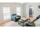 Bright living room with large windows, an armchair, and view of doors leading to another room at 1699 Riverdale Dr, Rock Hill, SC 29732