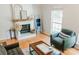 Bright and airy living room showcasing a decorative fireplace and comfortable armchair by the window at 1699 Riverdale Dr, Rock Hill, SC 29732