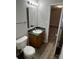 Bathroom features a toilet, sink, mirror, and vanity with faux marble countertop at 1714 Maribel Ave, Charlotte, NC 28216