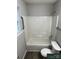 A full white tub and shower combo features in the home's bathroom at 1714 Maribel Ave, Charlotte, NC 28216