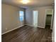 Bright bedroom with bathroom and closet doorway views; features hardwood floors and natural lighting at 1714 Maribel Ave, Charlotte, NC 28216