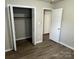 The primary bedroom has a closet with hardwood floors and easy access to the bathroom at 1714 Maribel Ave, Charlotte, NC 28216