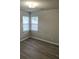 This bedroom features hardwood floors, natural light, and neutral-colored walls at 1714 Maribel Ave, Charlotte, NC 28216