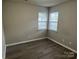 This cozy bedroom includes hardwood flooring and natural light coming from two windows at 1714 Maribel Ave, Charlotte, NC 28216