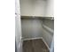 Walk-in closet featuring hardwood flooring, rod, and ample storage space for organizing clothes at 1714 Maribel Ave, Charlotte, NC 28216
