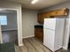 Kitchen featuring wood-look floors, wood cabinets, and a white refrigerator with view into adjacent room at 1714 Maribel Ave, Charlotte, NC 28216