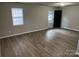 Bright living room featuring modern wood-look flooring, neutral paint, and ample natural light from a window at 1714 Maribel Ave, Charlotte, NC 28216