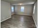 Open living room with ample natural light, hardwood-style floors, and neutral walls at 1714 Maribel Ave, Charlotte, NC 28216