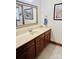 Elegant bathroom features warm wood cabinets with a luxurious countertop and tiled flooring at 212 Countryside Rd, Kings Mountain, NC 28086