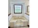 Bathroom featuring a large soaking tub with a window view, creating a spa-like experience at 212 Countryside Rd, Kings Mountain, NC 28086