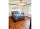 Comfortable bedroom featuring hardwood floors, soft lighting and cozy blue floral bedding at 212 Countryside Rd, Kings Mountain, NC 28086
