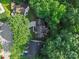 Overhead perspective of a house with a driveway nestled among mature trees, highlighting the property's privacy at 216 Devon Forest Dr, Mooresville, NC 28115