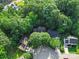 Aerial view showcases the house surrounded by mature trees, in a neighborhood with tree-lined streets at 216 Devon Forest Dr, Mooresville, NC 28115