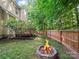 Backyard featuring a cozy fire pit, a privacy fence, and lush green grass at 216 Devon Forest Dr, Mooresville, NC 28115