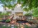 Charming backyard featuring a wooden deck, lush greenery, and well-maintained landscaping at 216 Devon Forest Dr, Mooresville, NC 28115