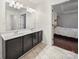 Bathroom with tiled floors, a double sink vanity, and a bright doorway at 216 Devon Forest Dr, Mooresville, NC 28115