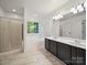 Bathroom showcasing tiled floors, a double sink vanity, a soaking tub and a glass enclosed shower at 216 Devon Forest Dr, Mooresville, NC 28115