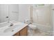Bright bathroom featuring a shower-tub combo, modern fixtures, and a stylish vanity sink at 216 Devon Forest Dr, Mooresville, NC 28115