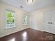 Bedroom featuring hardwood floors, large windows, and a closet at 216 Devon Forest Dr, Mooresville, NC 28115