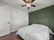 Comfortable bedroom featuring a ceiling fan, hardwood floors, and a calming accent wall at 216 Devon Forest Dr, Mooresville, NC 28115