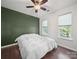 Bedroom featuring an accent wall, hardwood floors, and bright windows at 216 Devon Forest Dr, Mooresville, NC 28115