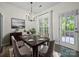 A charming dining room features a table set for six, a modern chandelier, and access to the backyard at 216 Devon Forest Dr, Mooresville, NC 28115