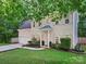 Beautiful two-story home with lush landscaping and a welcoming entrance, showcasing a well-maintained front yard at 216 Devon Forest Dr, Mooresville, NC 28115