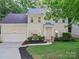 Charming two-story home featuring a well-manicured lawn and a classic facade with neutral siding and shutters at 216 Devon Forest Dr, Mooresville, NC 28115