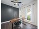Bright home office with modern desk, comfortable chair, and large windows offering a pleasant workspace at 216 Devon Forest Dr, Mooresville, NC 28115
