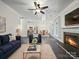 Inviting living room featuring a cozy fireplace, stylish furnishings, and an open-concept layout at 216 Devon Forest Dr, Mooresville, NC 28115