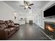 Spacious living area with a fireplace, hardwood floors, and open layout to the kitchen and dining area at 216 Devon Forest Dr, Mooresville, NC 28115