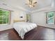 Bright bedroom with dark hardwood floors and large windows at 216 Devon Forest Dr, Mooresville, NC 28115