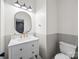 Elegant powder room featuring a modern vanity with gold fixtures, a stylish mirror, and a sleek toilet at 216 Devon Forest Dr, Mooresville, NC 28115
