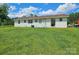 Expansive backyard showcasing a well-maintained lawn and the rear exterior of the house at 3546 Kershaw Camden Hwy, Lancaster, SC 29720