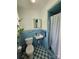 Retro bathroom with blue tile, classic fixtures, and a shower with a white curtain at 3546 Kershaw Camden Hwy, Lancaster, SC 29720