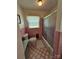 Vintage bathroom with pink tiles and a glass-enclosed tub/shower combination at 3546 Kershaw Camden Hwy, Lancaster, SC 29720