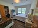 Bedroom with wood-look flooring, neutral walls, and a closet with an open door, plus a window and furniture at 3546 Kershaw Camden Hwy, Lancaster, SC 29720