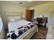 Bright bedroom with a desk, wood-look floors, and a bed with a decorative blanket at 3546 Kershaw Camden Hwy, Lancaster, SC 29720
