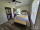 Cozy bedroom featuring an upholstered headboard, a bench at the end of the bed, and an organized closet at 3546 Kershaw Camden Hwy, Lancaster, SC 29720