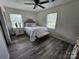 Bright bedroom with wood-look floors and a bed with decorative pillows and throw, plus a nearby nightstand at 3546 Kershaw Camden Hwy, Lancaster, SC 29720