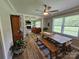 The dining room has a view to the living room and features a rustic table, ample light, and wood floors at 3546 Kershaw Camden Hwy, Lancaster, SC 29720
