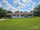 Charming one-story home with a white brick exterior and well-manicured front lawn at 3546 Kershaw Camden Hwy, Lancaster, SC 29720