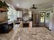 Well-lit kitchen featuring stainless steel appliances, granite countertops, and a modern ceiling fan at 3546 Kershaw Camden Hwy, Lancaster, SC 29720