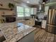 Updated kitchen with stainless appliances, granite counters, and modern fixtures for a sleek, efficient design at 3546 Kershaw Camden Hwy, Lancaster, SC 29720