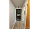 Conveniently stacked washer and dryer unit in an open closet with wood-look flooring at 3546 Kershaw Camden Hwy, Lancaster, SC 29720
