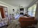 Cozy living room featuring a fireplace, comfortable seating, and a view into the bedroom at 3546 Kershaw Camden Hwy, Lancaster, SC 29720